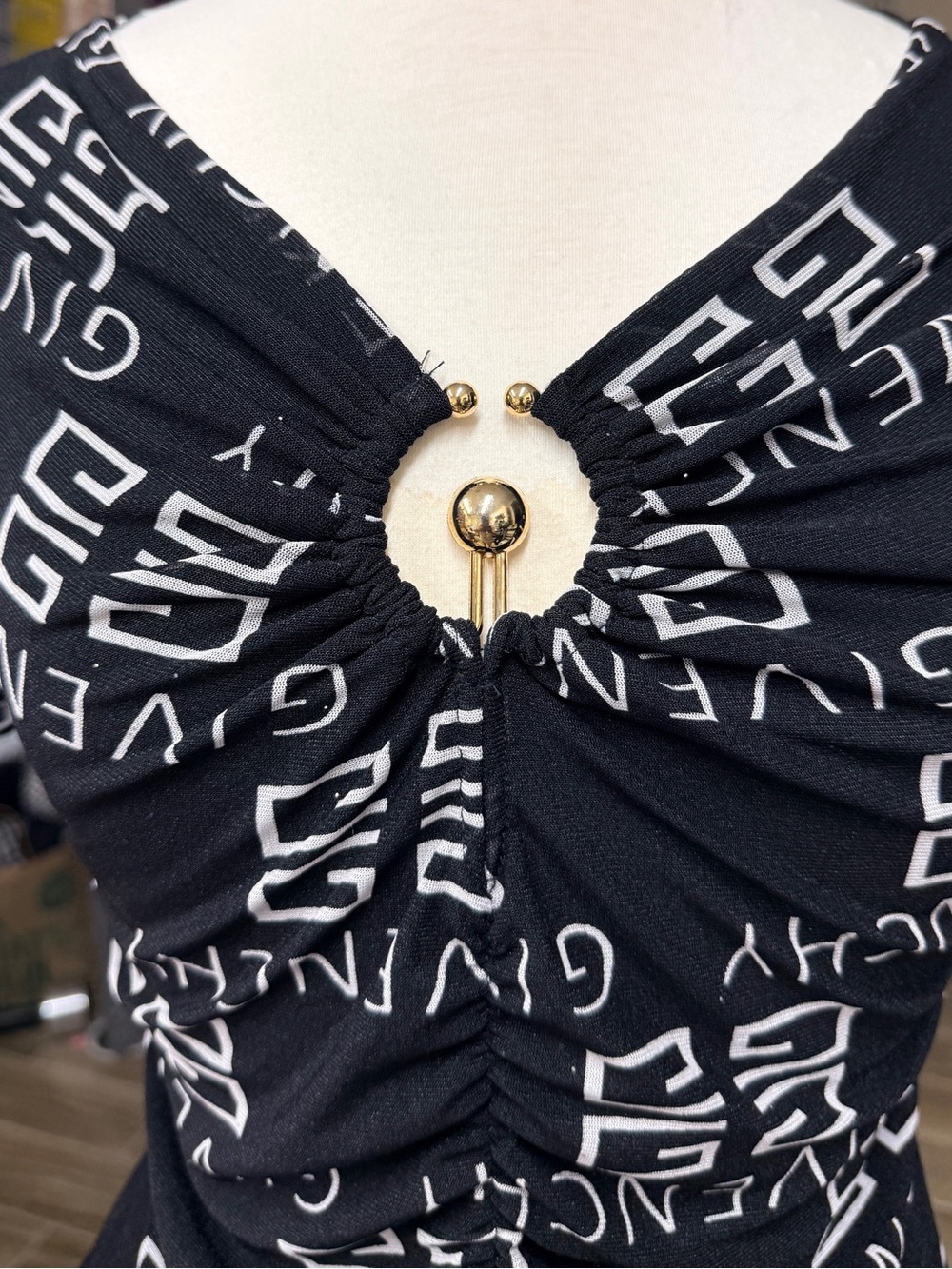 V neck Black Printed Ruched Top with Gold Ring Accent, very stretchy and fitted.